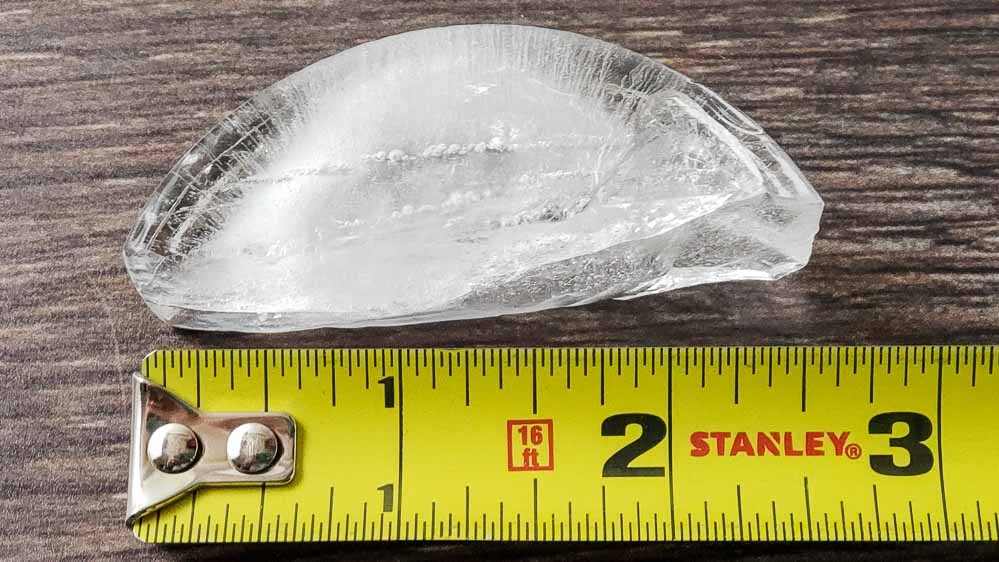 a crescent shaped ice cube and a measuring tape.