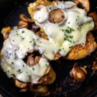 Mushroom Swiss Chicken in a cast iron skillet.