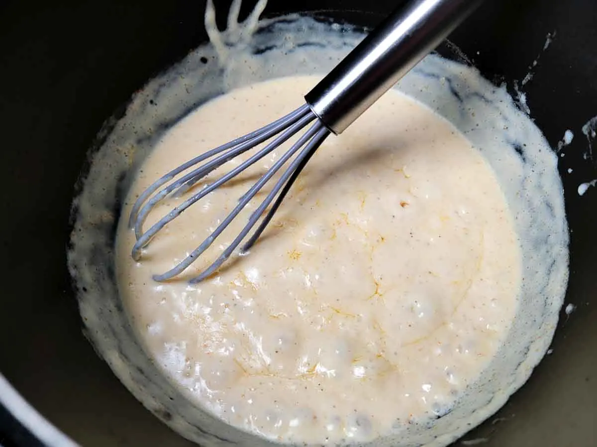cheese added to mixture in a sauce pan.