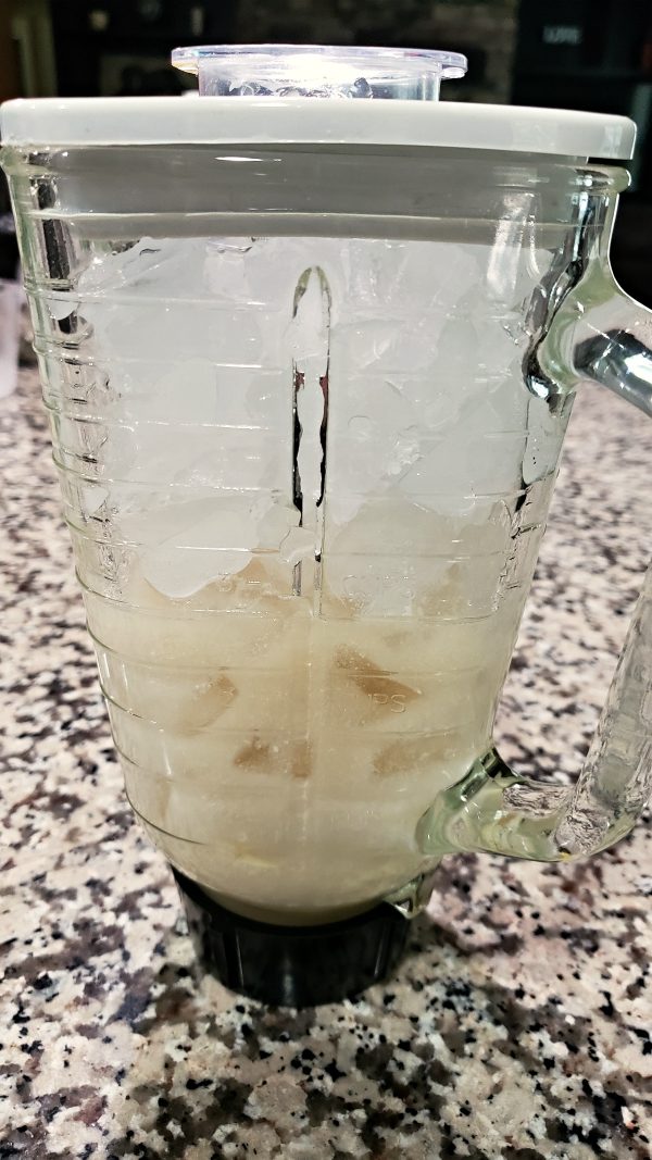 banana, coconut milk, lime juice, sugar, ice and spiced rum in a blender.