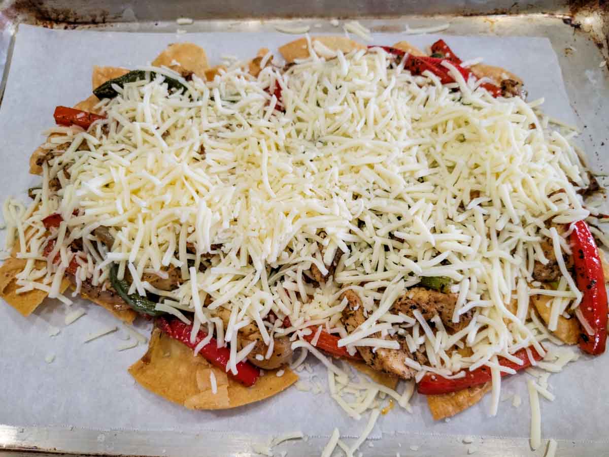 chicken fajita chips and cheese on a baking sheet.