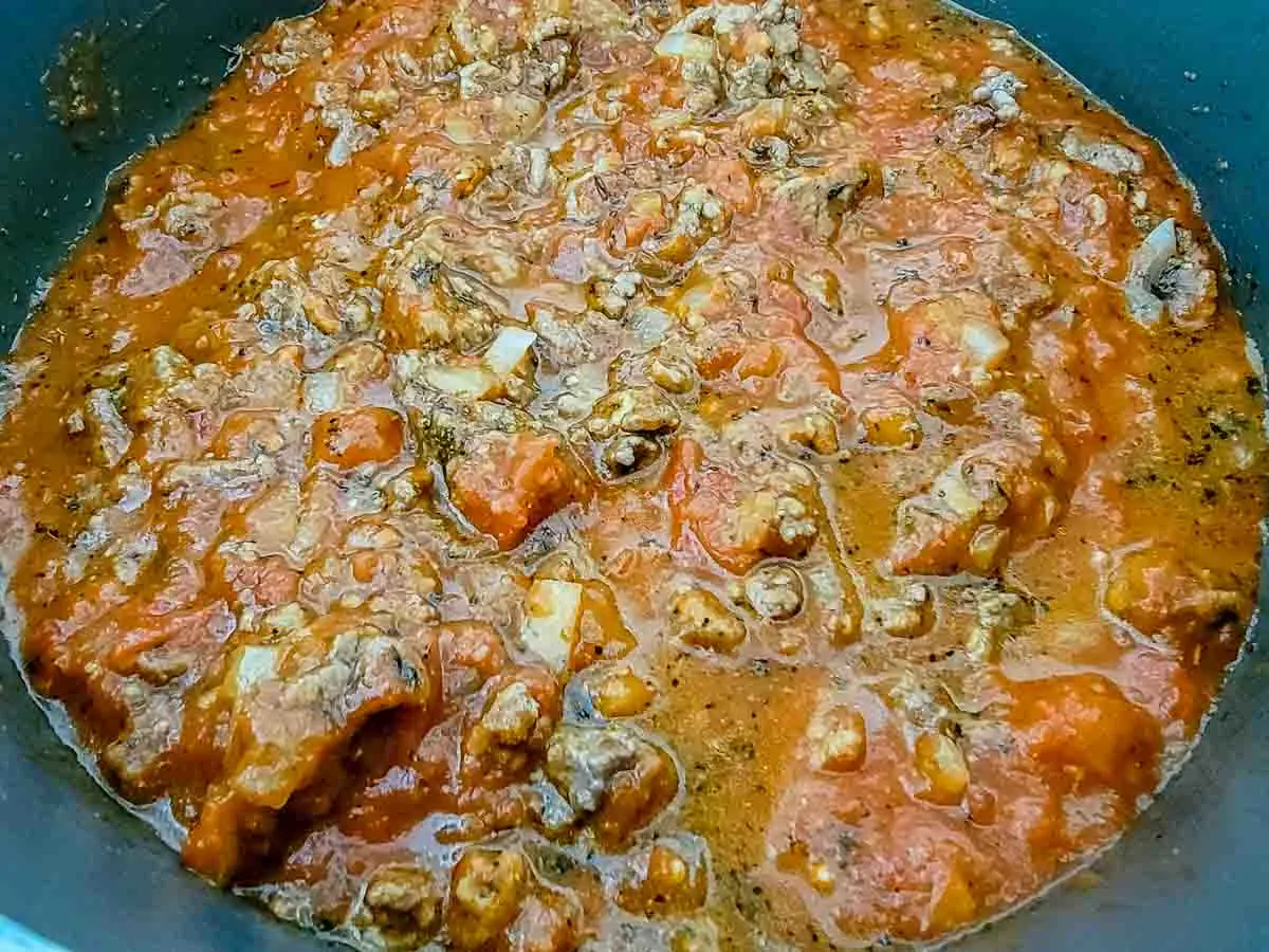 homemade spaghetti meat sauce cooking in a pan.