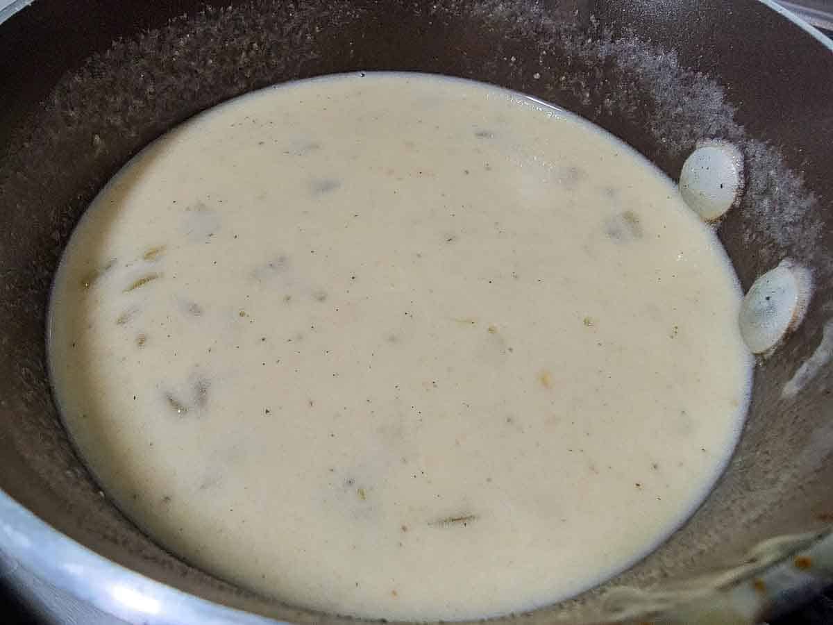 green chile white sauce cooking in a pan.