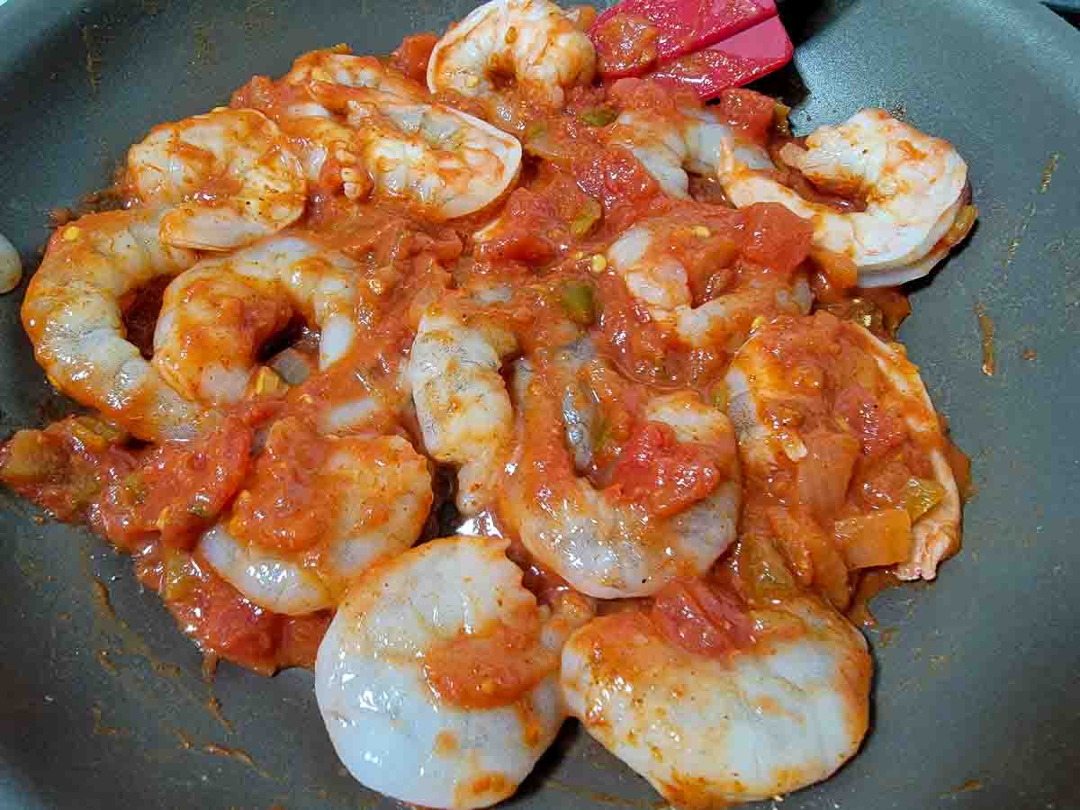 shrimp and salsa cooking in a pan.