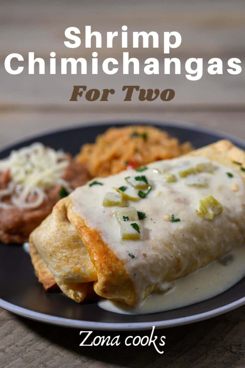 Chimichanga de Camaron on a plate with sides of spanish rice and refried beans.
