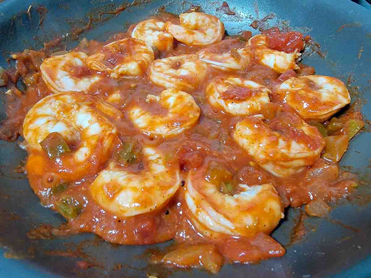 shrimp and salsa cooking in a pan.