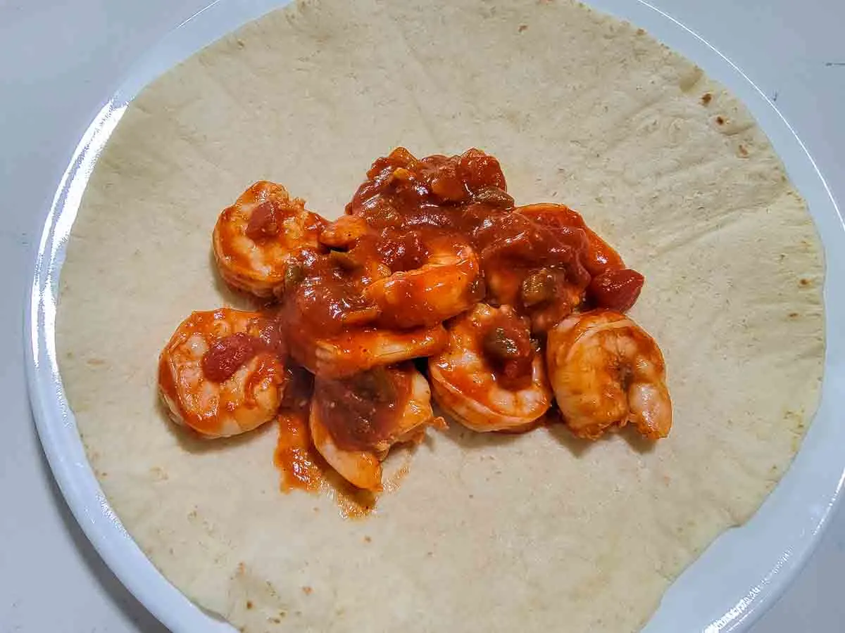 shrimp mixture on a large tortilla.