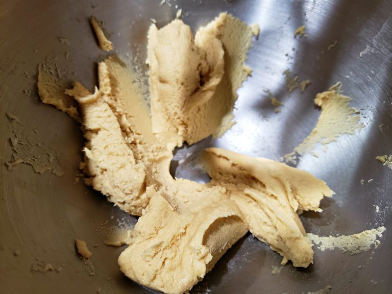 cookie dough mixed in a stand mixer bowl.