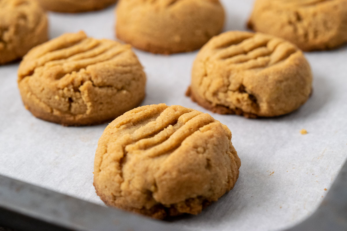 Soft and Chewy Peanut Butter Cookies on a baking sheet.