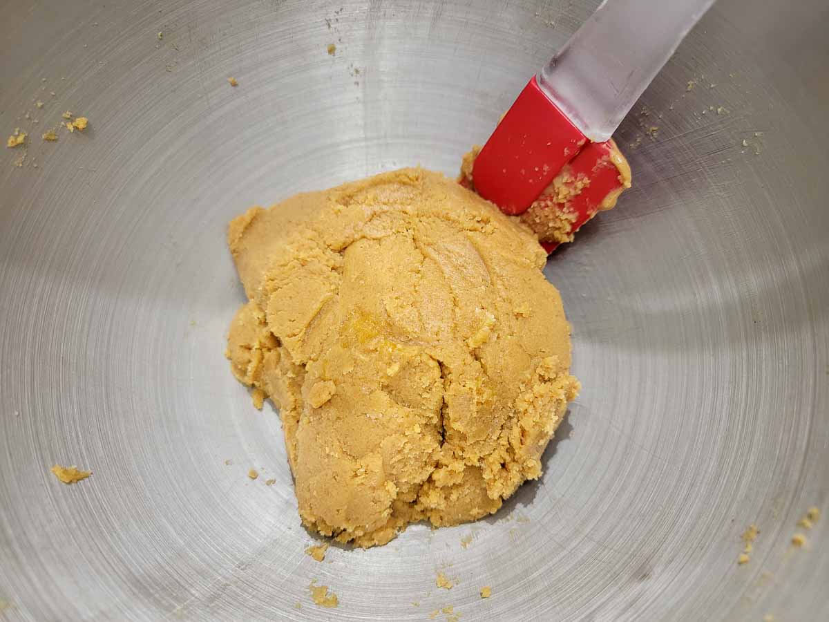 granulated sugar, brown sugar, peanut butter, and jumbo egg mixed in a bowl.