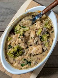Smothered Chicken and Rice in a baking dish with a spoon.