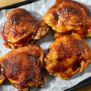 Baked BBQ Chicken Thighs on a baking sheet.