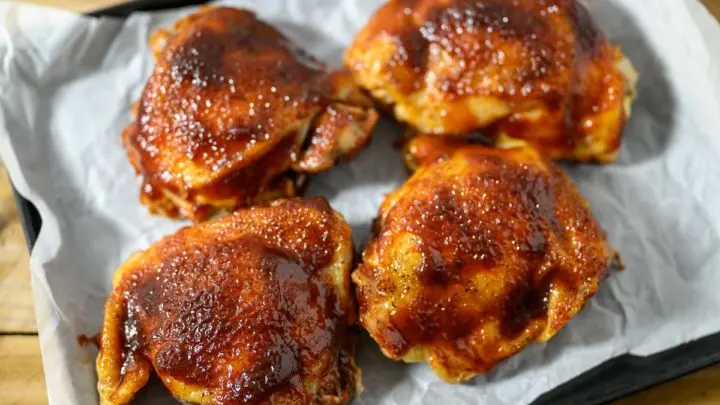 Baked BBQ Chicken Thighs on a baking sheet.