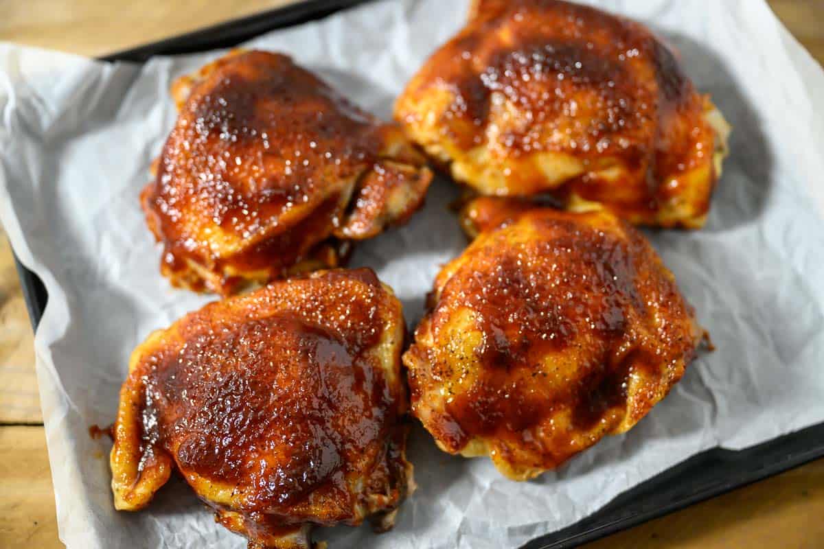 Baked BBQ Chicken Thighs on a baking sheet.