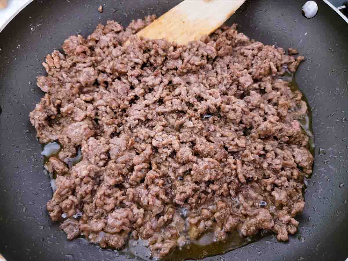 fajita seasoned ground beef cooking in a skillet.