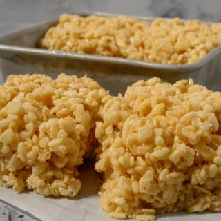 Small Batch of Rice Krispie Treats on parchment paper and in a pan.