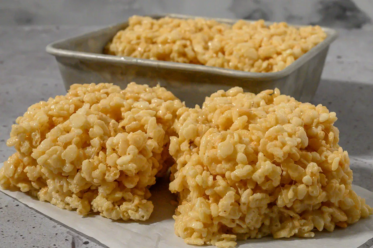 Small Batch of Rice Krispie Treats on parchment paper and in a pan.