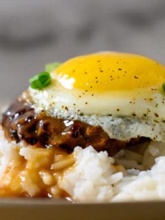 Easy Loco Moco with white rice topped with a beef patty, topped with brown gravy, topped with an egg on a plate.
