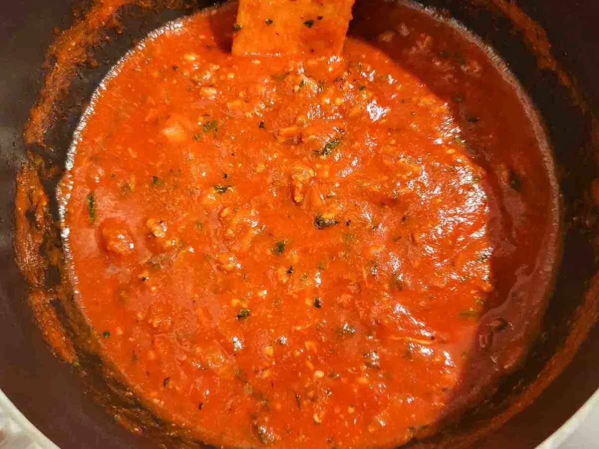 Authentic Homemade Spaghetti Sauce cooking in a pan.