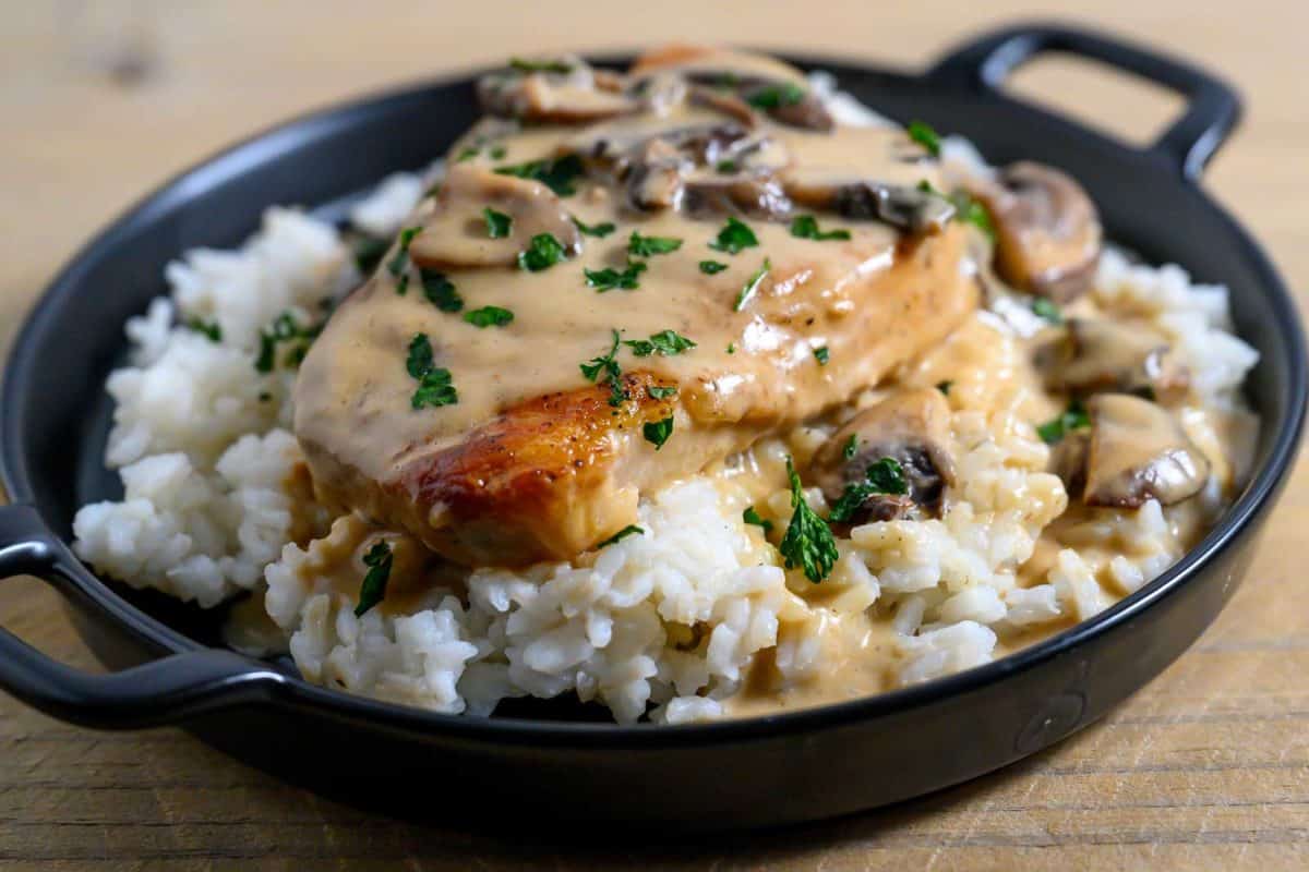 Creamy Pork Chops and Rice on a plate.