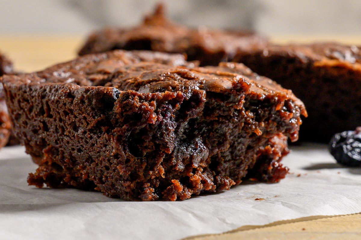 Blueberry Chocolate Brownies on parchment paper.