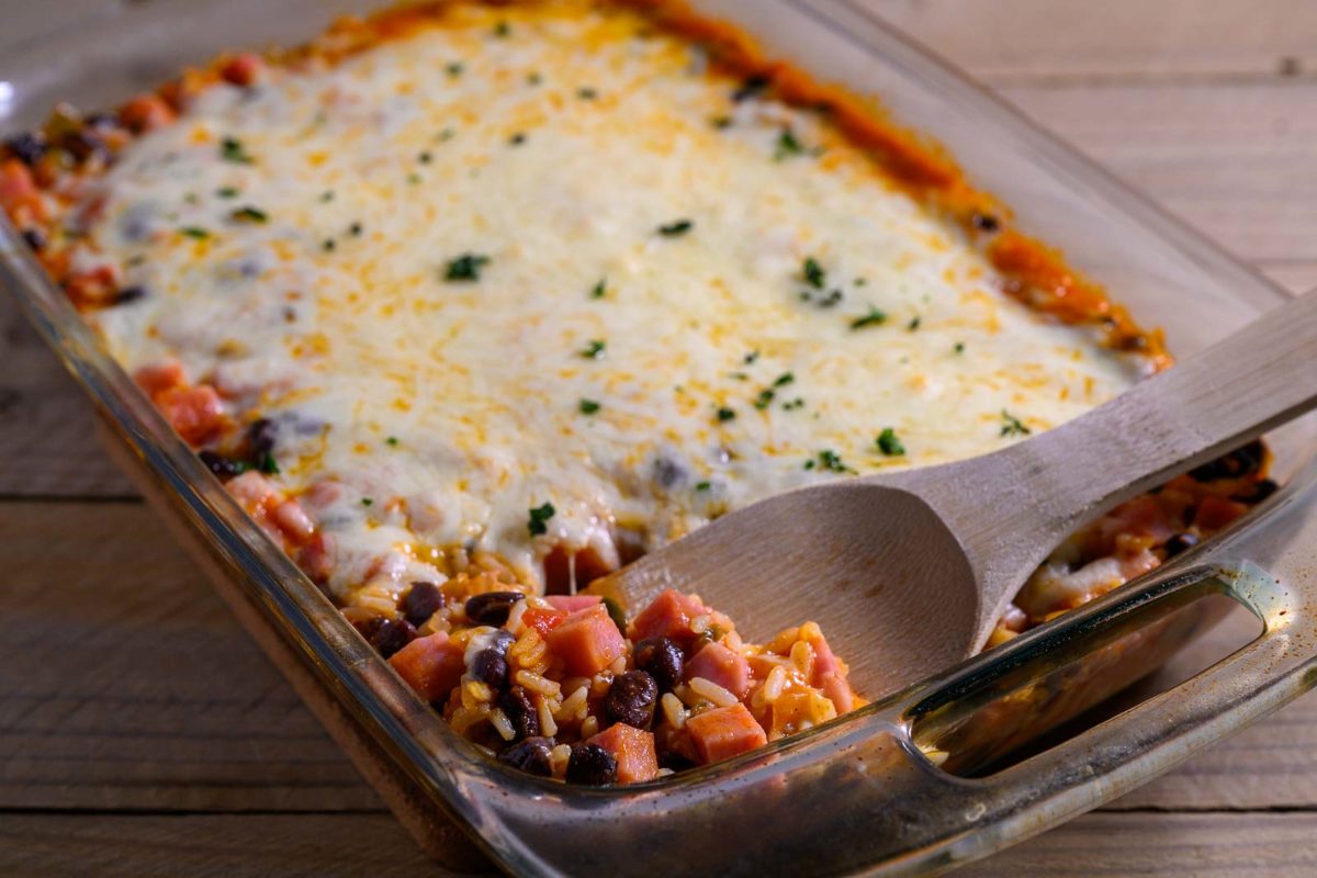 Spanish Rice Casserole with a spoon lifting some out.