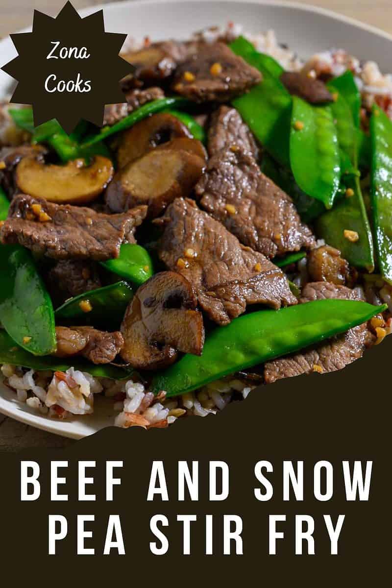 Beef and Snow Pea Stir Fry over rice on a plate.