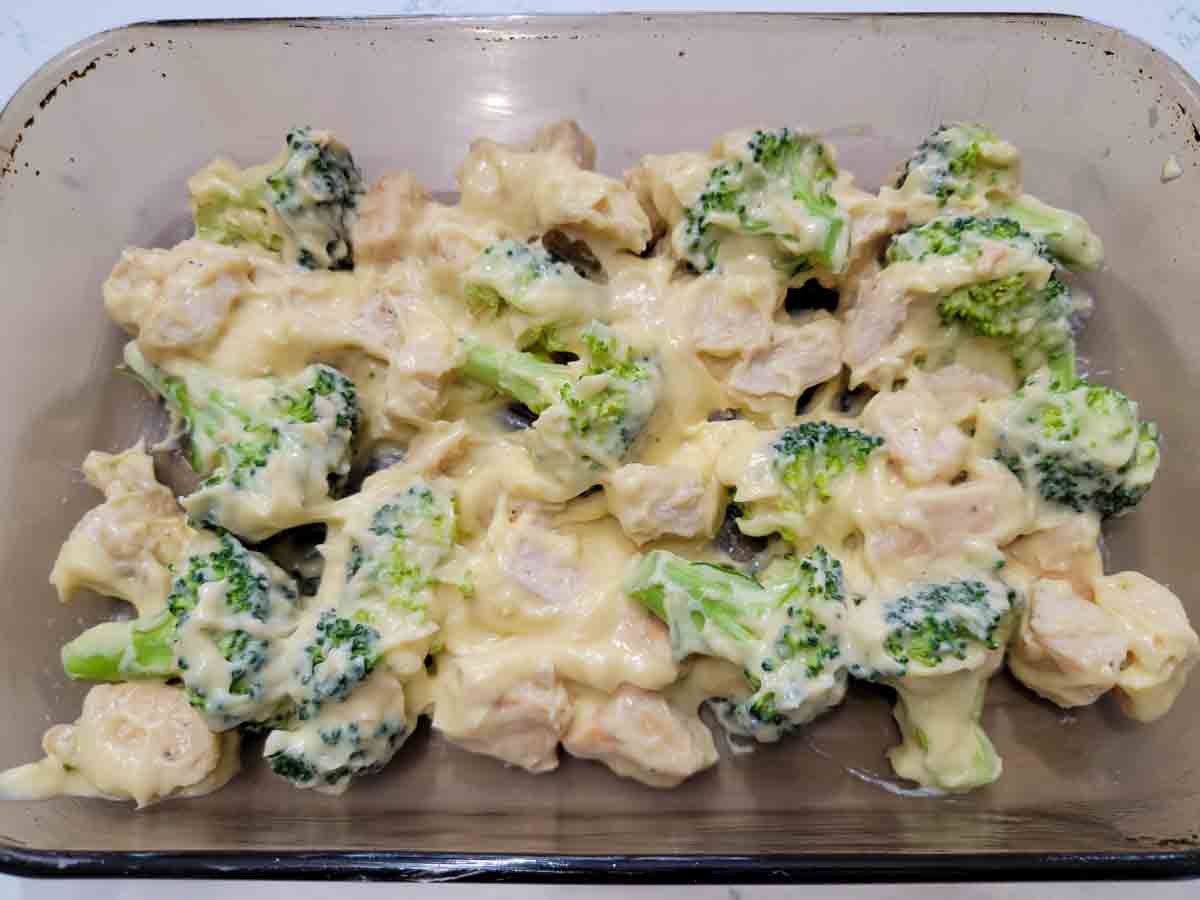 creamy chicken broccoli mixture in a baking dish.