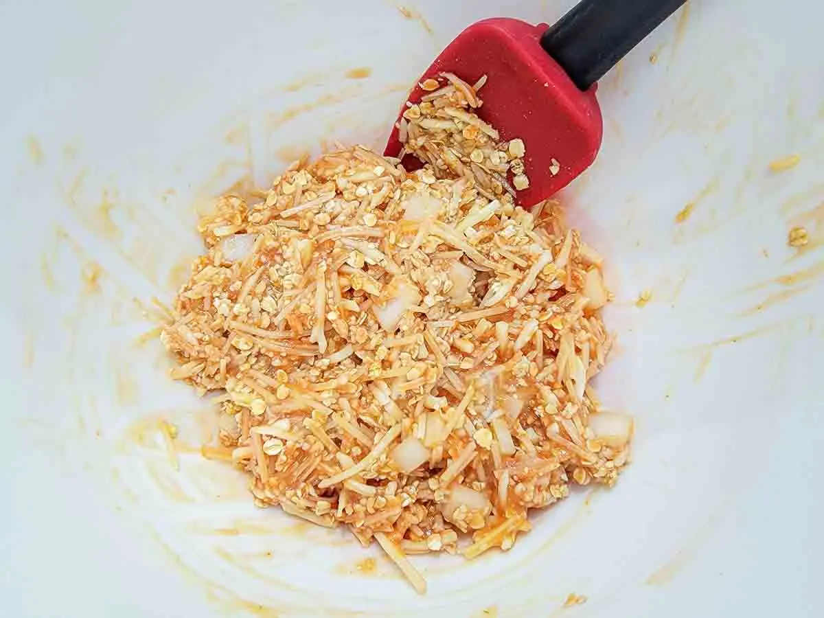 ketchup and egg are stirred into an oatmeal mixture.