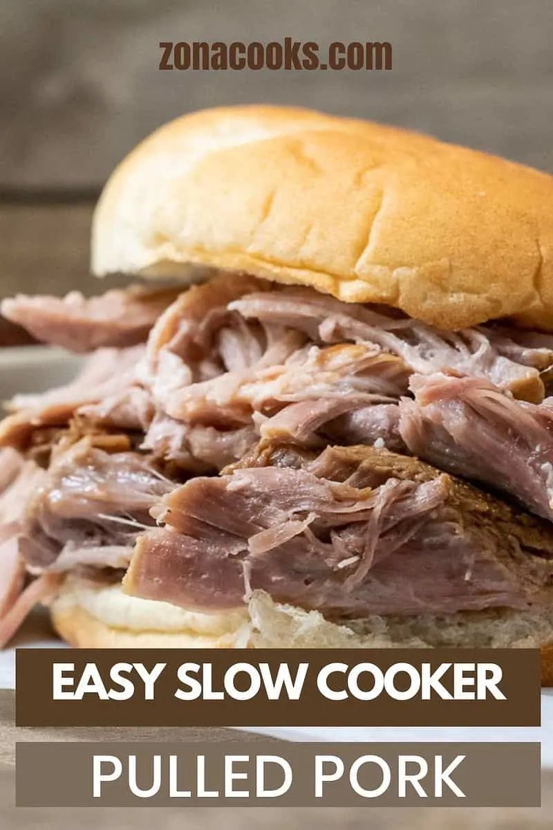 Easy Slow Cooker Pulled Pork piled high on a bun.