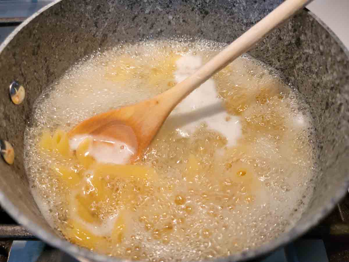 penne pasta cooking in a pan.