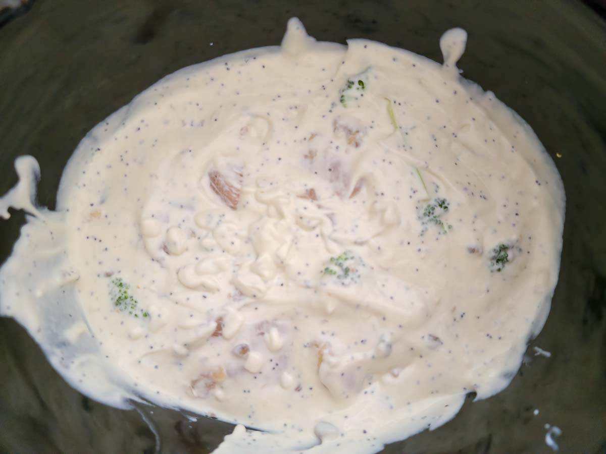 chicken, broccoli, and white poppy seed sauce in a crock pot.