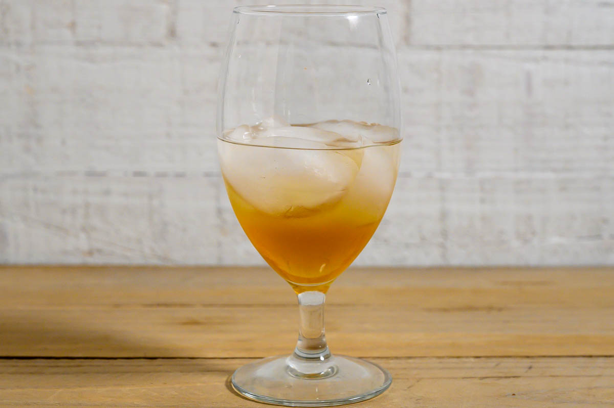 vodka, peanut butter whiskey, and ice in a tall glass.