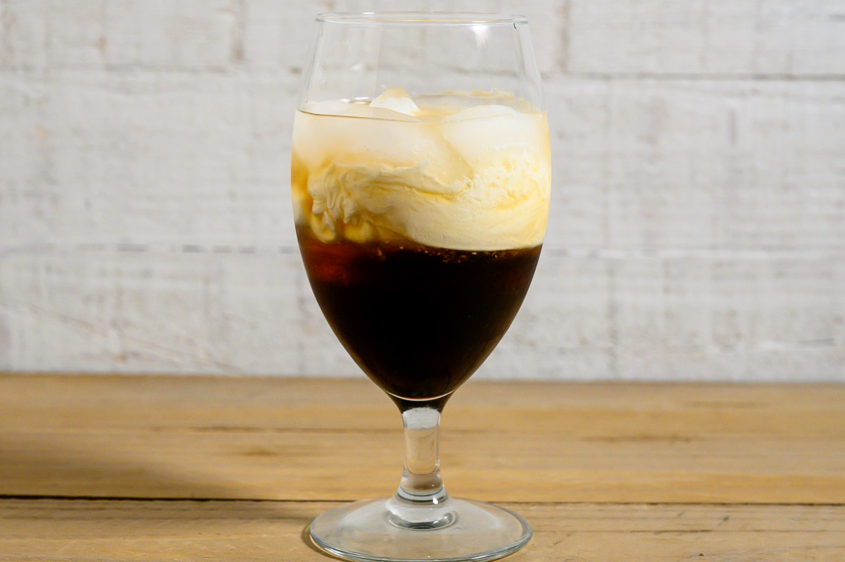 heavy cream, Kahlua, vodka, peanut butter whiskey, and ice in a tall glass.