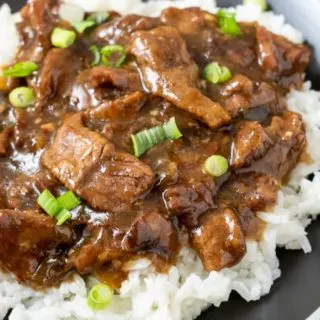 Crock Pot Mongolian Beef over rice on a plate.