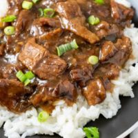 Crock Pot Mongolian Beef over rice on a plate.