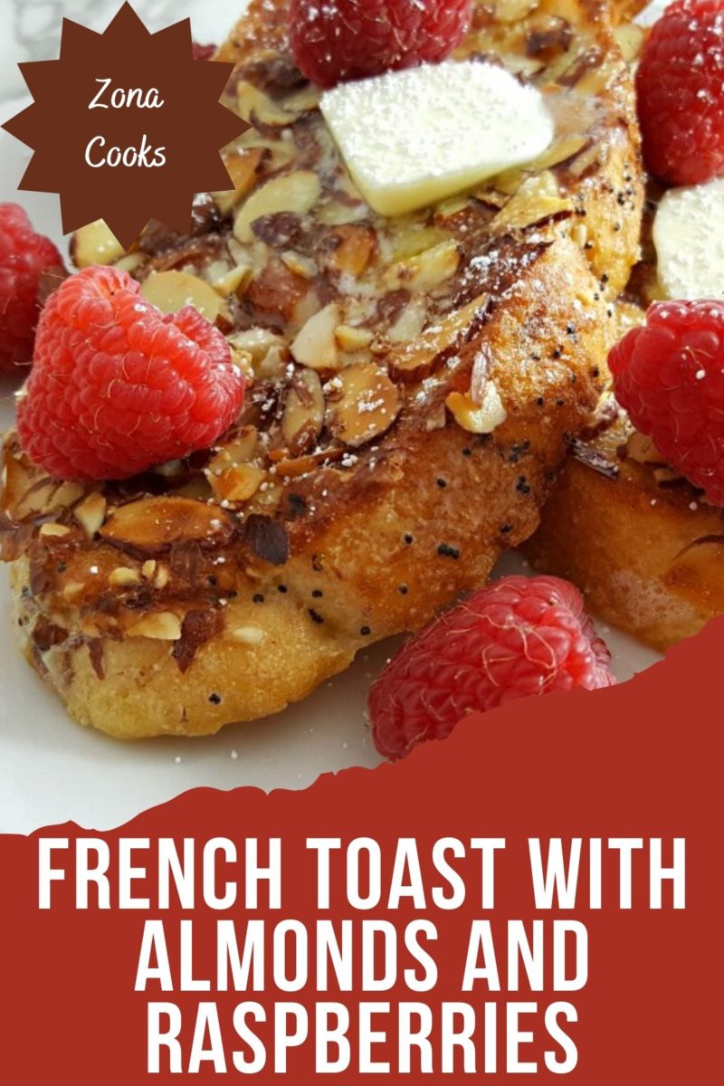 French Toast with Almonds and Raspberries on a plate.