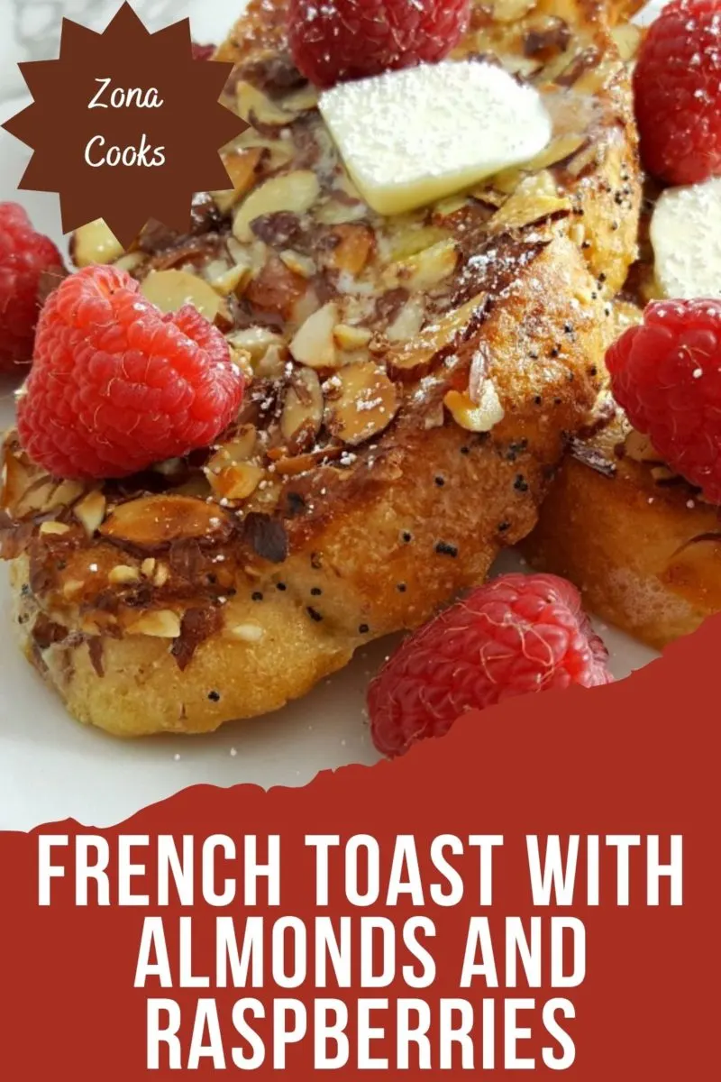 French Toast with Almonds and Raspberries on a plate.