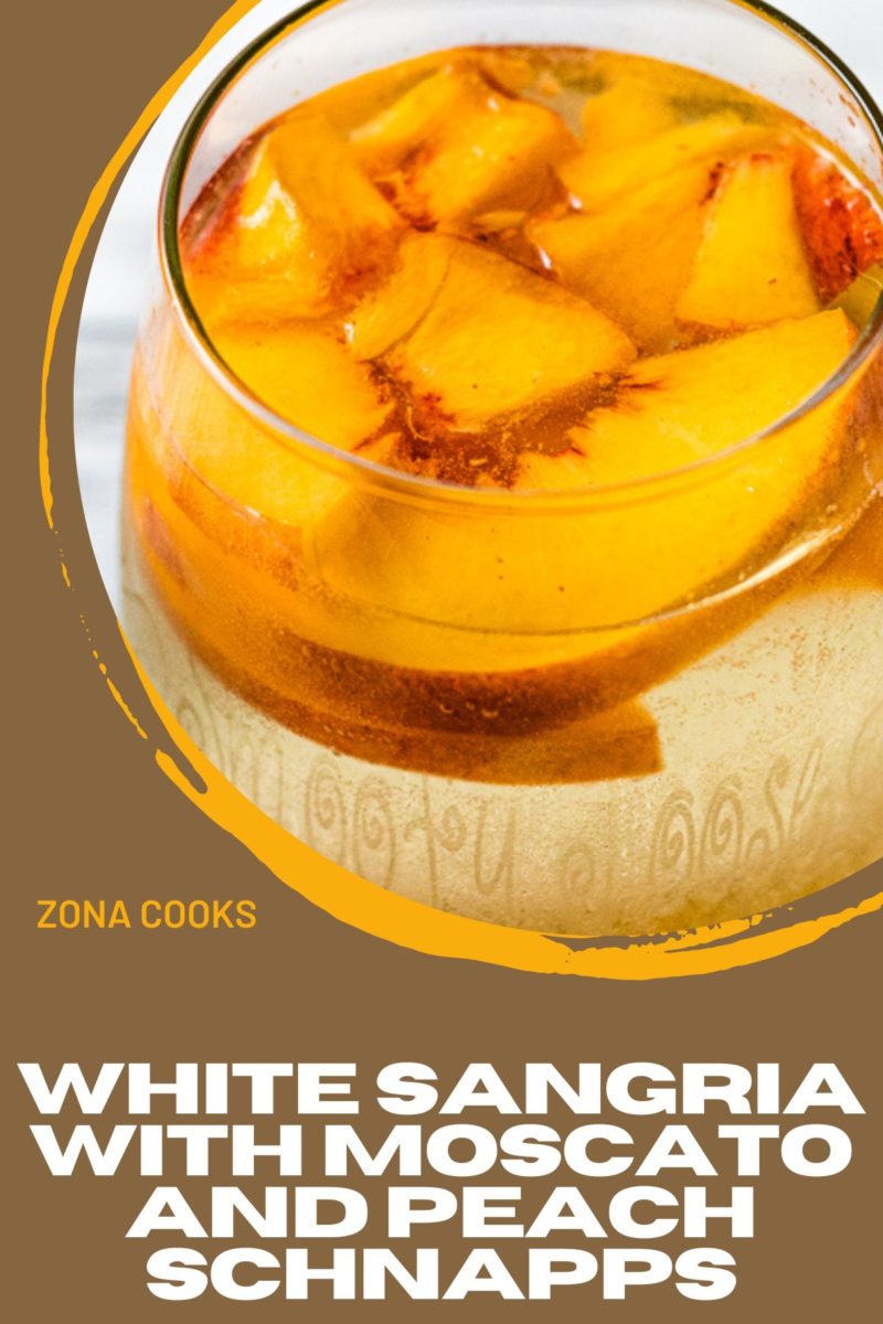 White Sangria with Moscato and Peach Schnapps in a glass with peach slices.