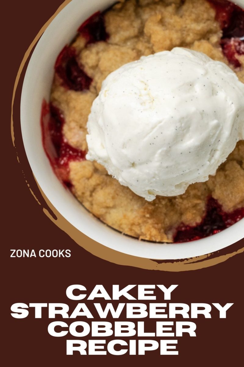 Cakey Strawberry Cobbler topped with vanilla bean ice cream.