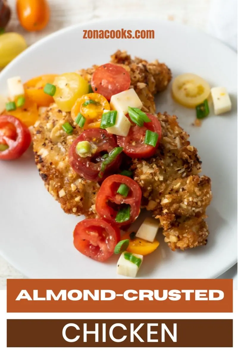Almond-crusted Chicken and tomatoes on a plate.