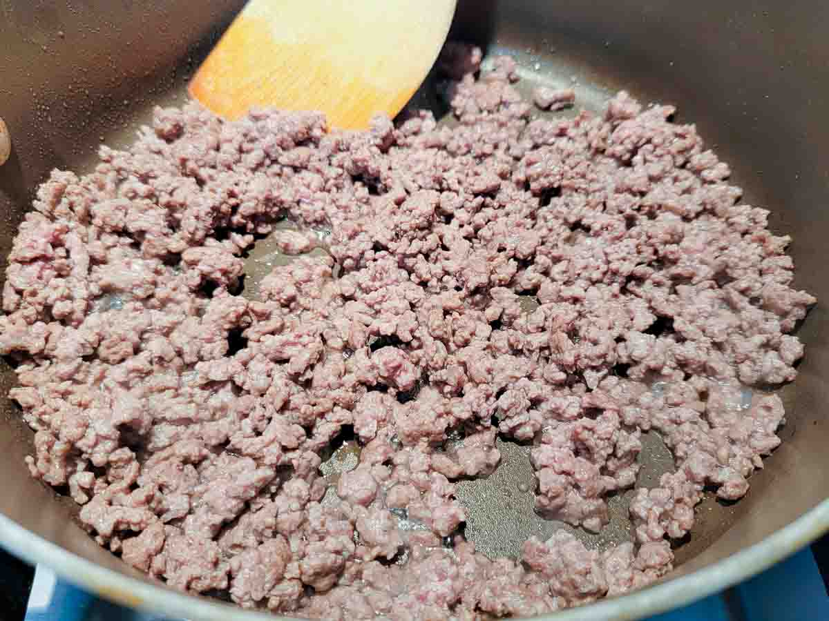 ground beef cooking in a frying pan.