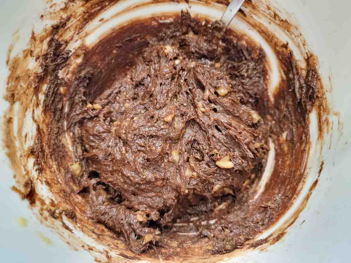 mashed bananas, cocoa powder, sugar, and peanut butter in a bowl.