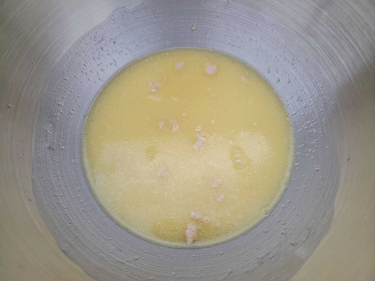 warm water, yeast, sugar, melted butter, and salt in a bowl.