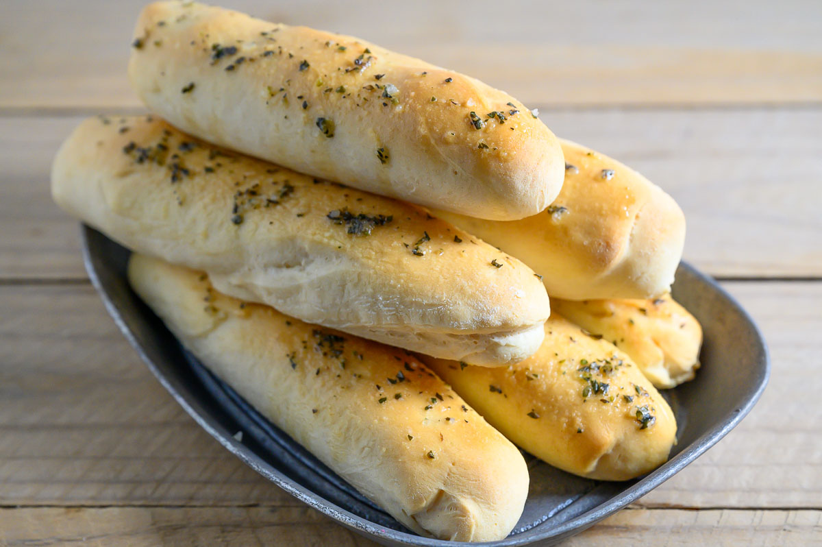 6 Ingredient Italian Breadsticks in a bread tray.