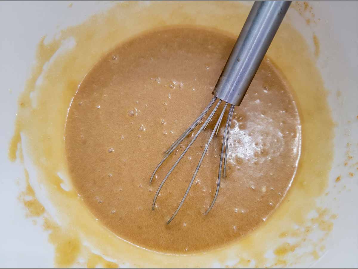 banana bread wet ingredients whisked in a bowl.