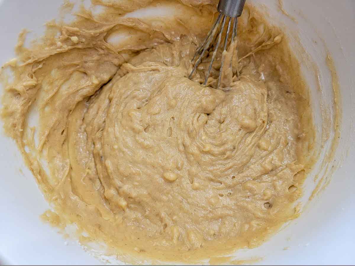 banana bread batter whisked in a bowl.