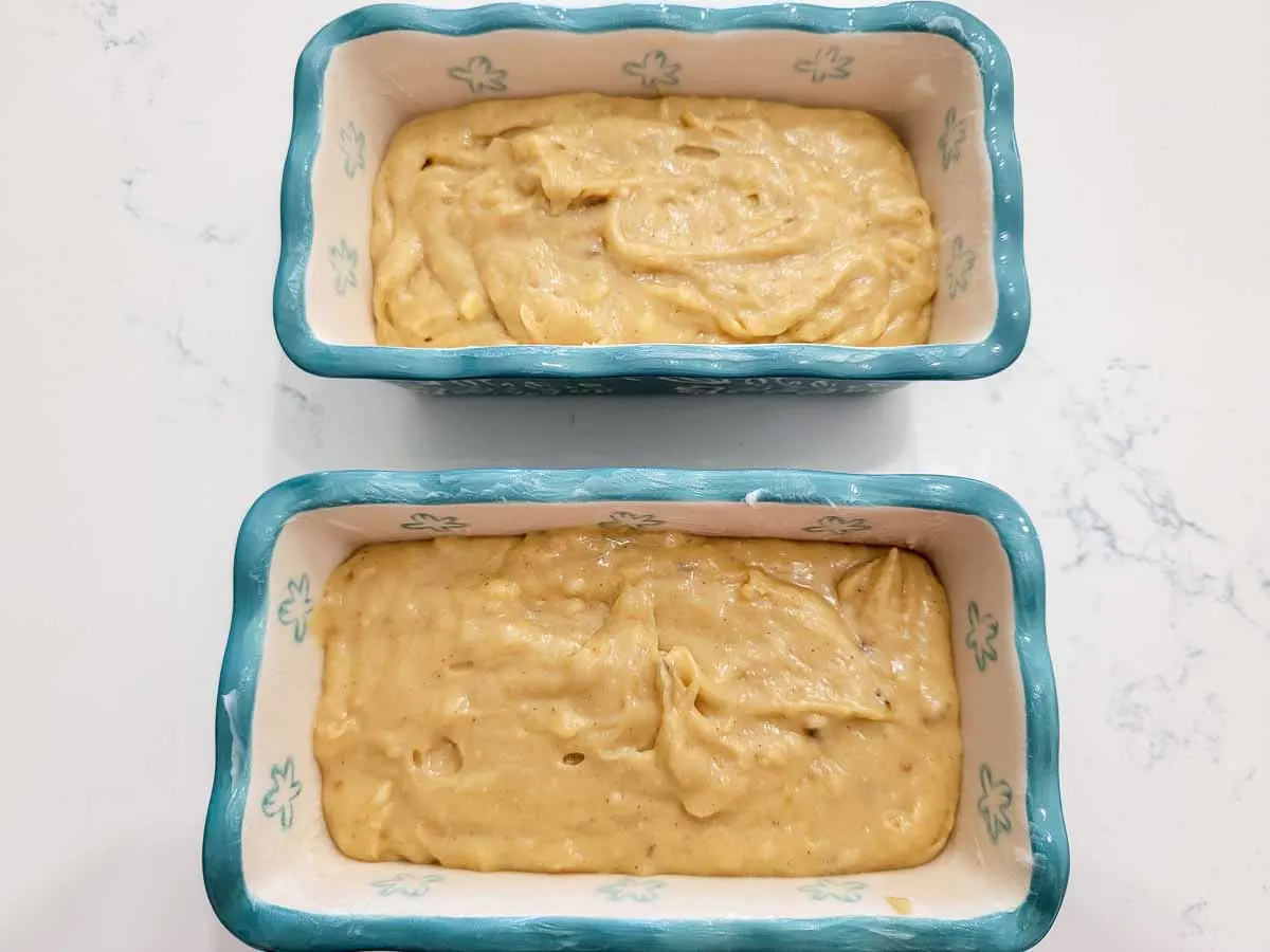 banana bread batter in two mini loaf pans.