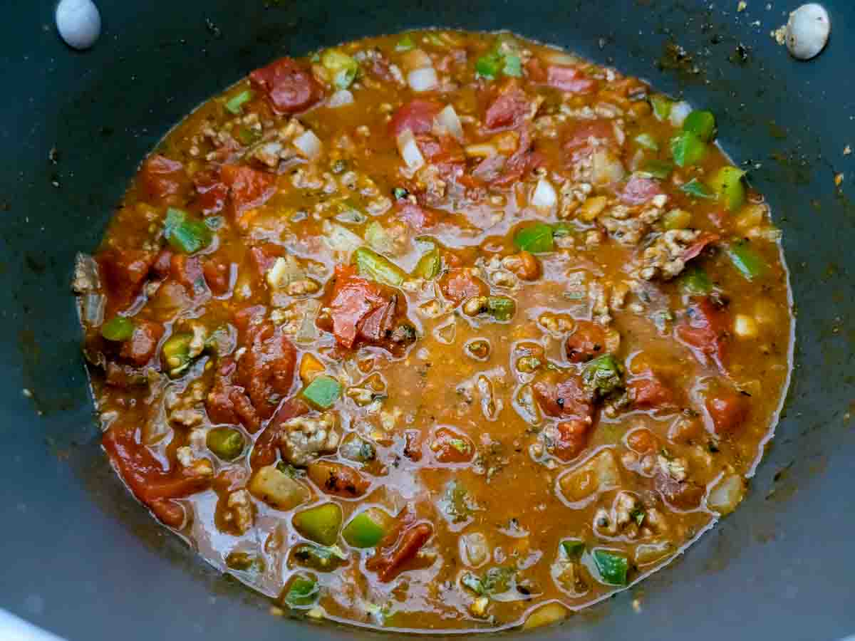veggie and meat spaghetti sauce cooking in a pan.