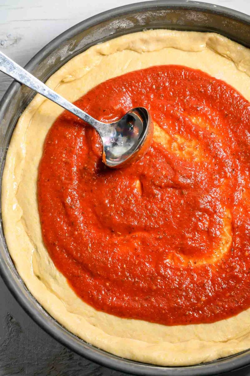 5 Minute Pizza Sauce spread on pizza dough.